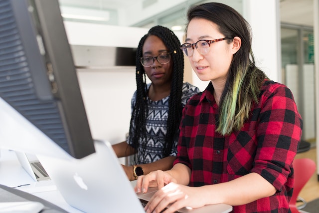 two people working on a desktop